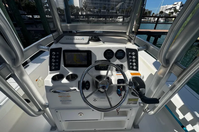 Slide: The Image of 2015 Robalo 226 Cayman boat dashboard with Garmin navigation system and steering wheel. - 28