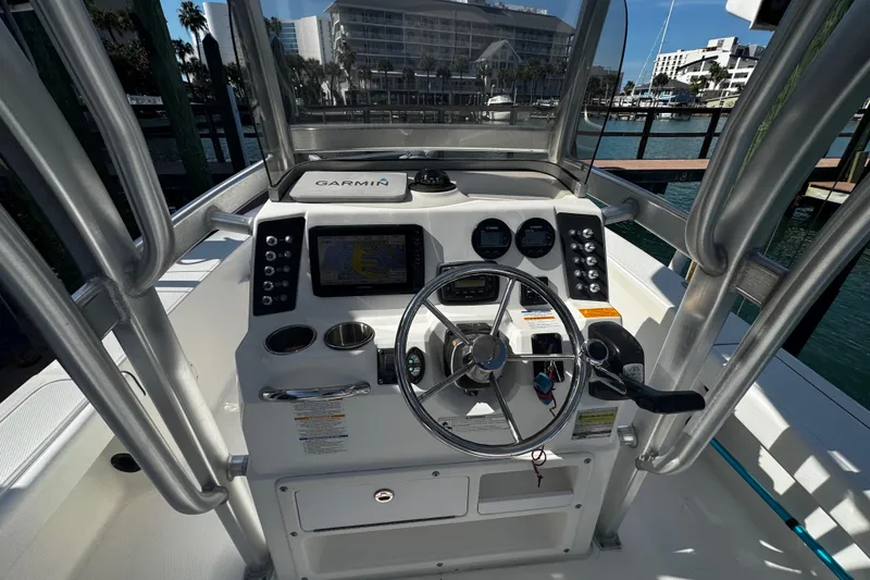 Slide: The Image of 2015 Robalo 226 Cayman boat dashboard with Garmin navigation system and steering wheel. - 29