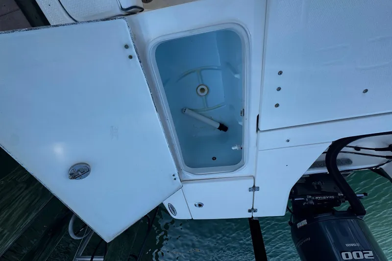 Slide: The Image of Open storage compartment on a 2015 Robalo 226 Cayman boat, showing interior details. - 33