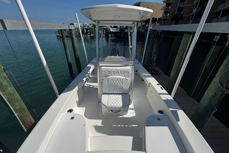 Slide: The Image of 2015 Robalo 226 Cayman boat docked, showcasing spacious deck and seating. - 35