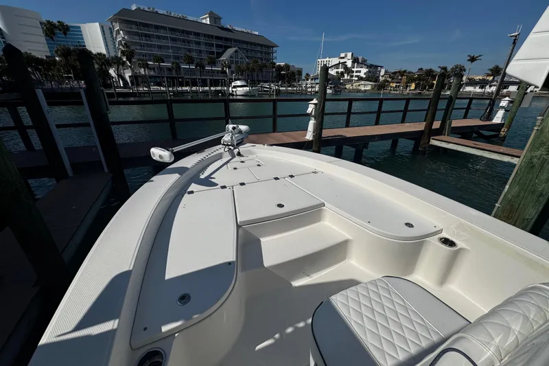 Slide: The Image of 2015 Robalo 226 Cayman boat docked at marina with scenic waterfront view. - 37