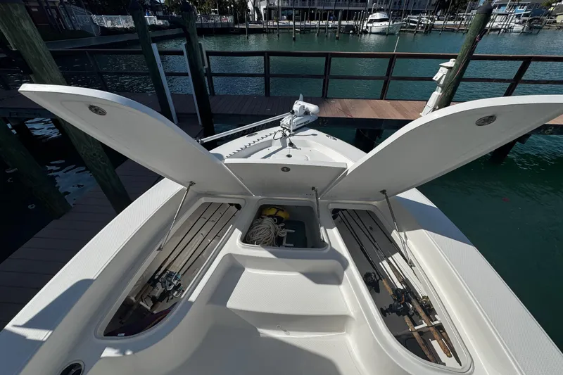 Slide: The Image of 2015 Robalo 226 Cayman boat with open storage compartments at dock. - 41
