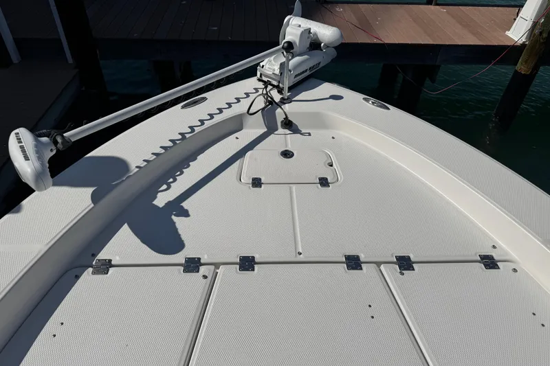 Slide: The Image of 2015 Robalo 226 Cayman boat deck with trolling motor at dock. - 42