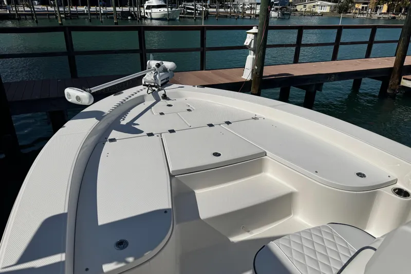 Slide: The Image of 2015 Robalo 226 Cayman boat deck with seating, docked by the water. - 43