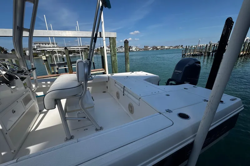 Slide: The Image of 2015 Robalo 226 Cayman boat docked by the water, featuring a Yamaha 200 engine. - 44