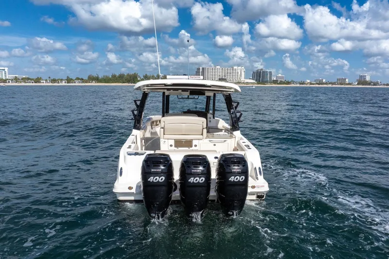 Slide: The Image of 2023 Boston Whaler 350 Realm with quad 400 engines on open water. - 2