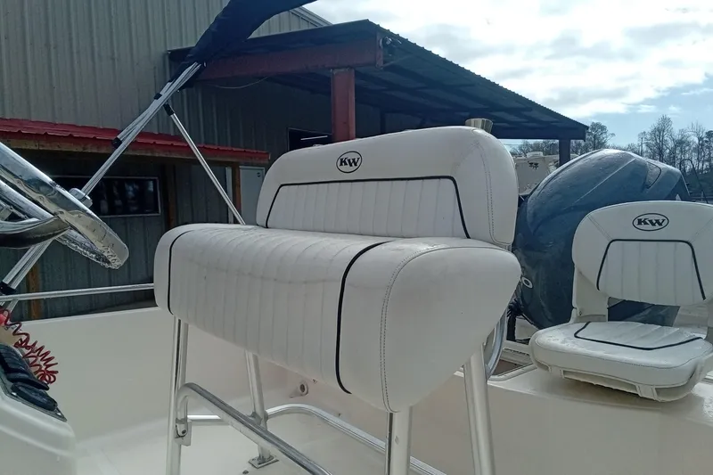 Slide: The Image of 2007 Key West 196 Bay Reef boat interior with white seating and steering wheel. - 17