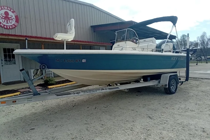 Slide: The Image of 2007 Key West 196 Bay Reef boat on trailer outside a building. - 21