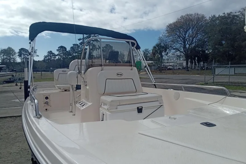 Slide: The Image of 2007 Key West 196 Bay Reef boat with canopy, parked outdoors under cloudy sky. - 6