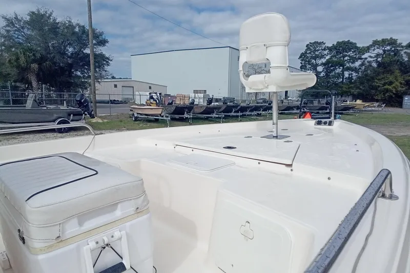 Slide: The Image of 2007 Key West 196 Bay Reef boat interior with seating and storage, parked outdoors. - 7