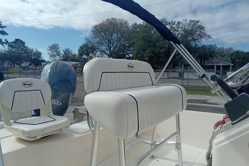 Slide: The Image of 2007 Key West 196 Bay Reef boat interior with Yamaha engine, featuring white seating and console. - 8