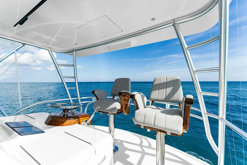Slide: The Image of Flybridge of 2026 Viking 50 Convertible yacht with ocean view and seating. - 5