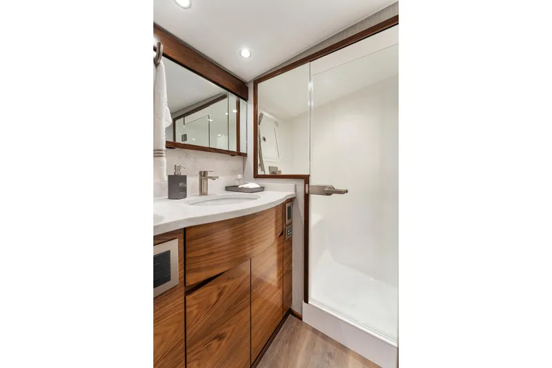 Slide: The Image of Luxurious bathroom in 2026 Viking 50 Convertible yacht with modern fixtures and wood cabinetry. - 14
