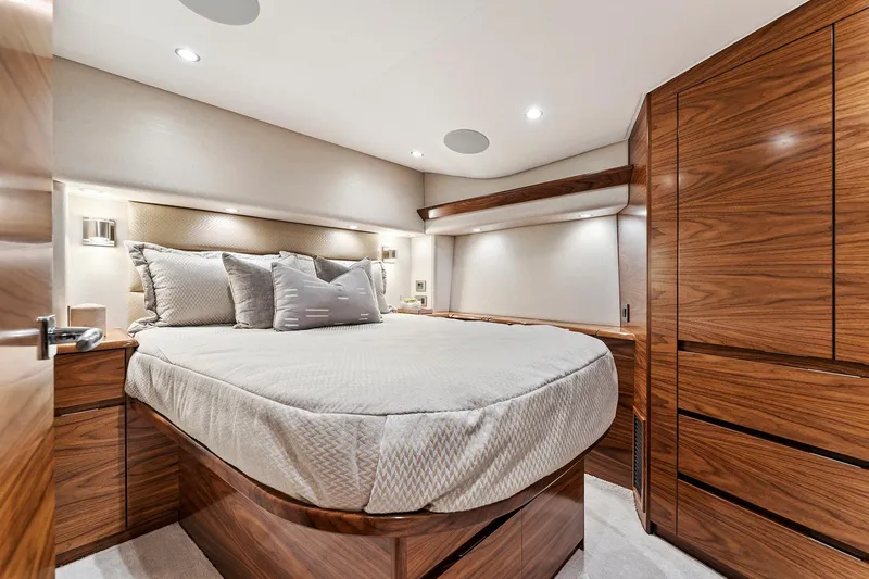 Slide: The Image of Luxurious bedroom interior of 2026 Viking 50 Convertible yacht with elegant wood finishes. - 12