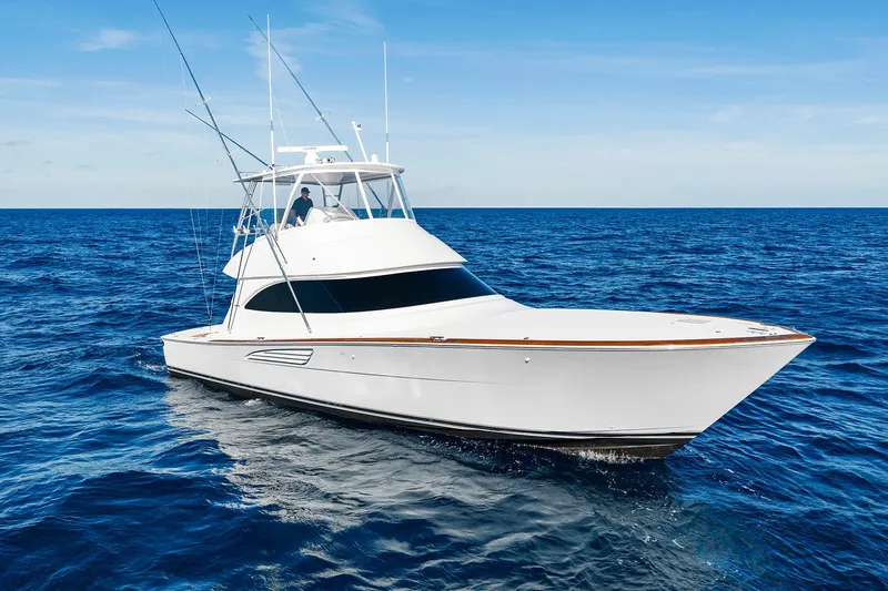 The Image of 2026 Viking 50 Convertible yacht cruising on open ocean under clear blue sky. - 1