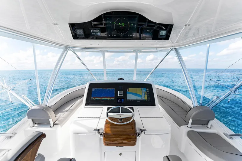 Slide: The Image of Helm of 2026 Viking 50 Convertible yacht with ocean view and advanced navigation displays. - 3