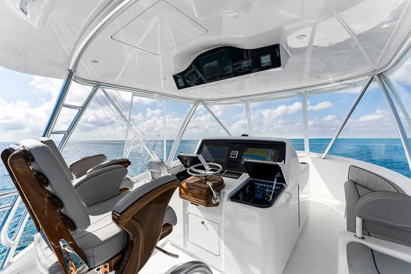 Slide: The Image of 2026 Viking 50 Convertible yacht helm with ocean view, featuring modern navigation equipment. - 4