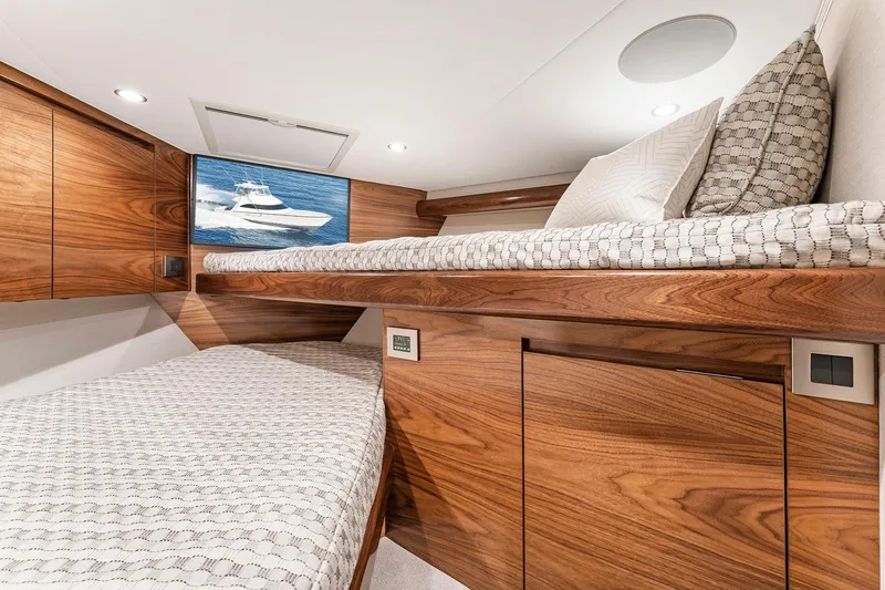 Slide: The Image of Luxurious 2026 Viking 50 Convertible yacht cabin with wooden interior and cozy bedding. - 17