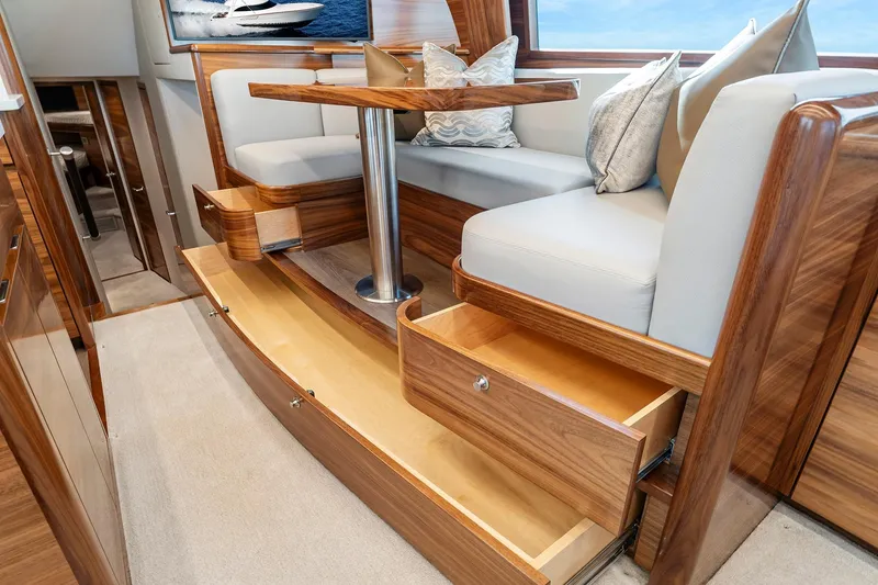 Slide: The Image of Luxurious interior of 2026 Viking 50 Convertible yacht with elegant seating and storage. - 10