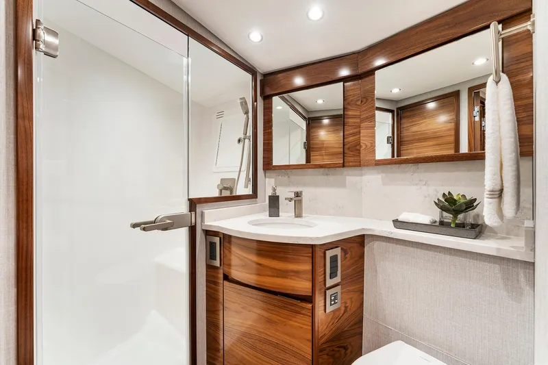 Slide: The Image of Luxurious bathroom in 2026 Viking 50 Convertible yacht with modern wood accents and sleek fixtures. - 16