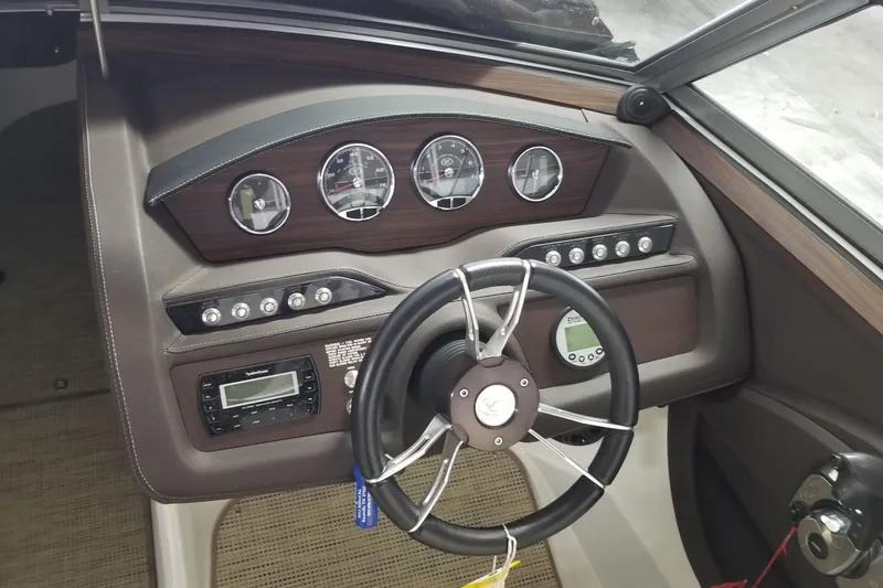 Slide: The Image of Dashboard of a 2015 Cobalt R5 boat with steering wheel and gauges. - 4