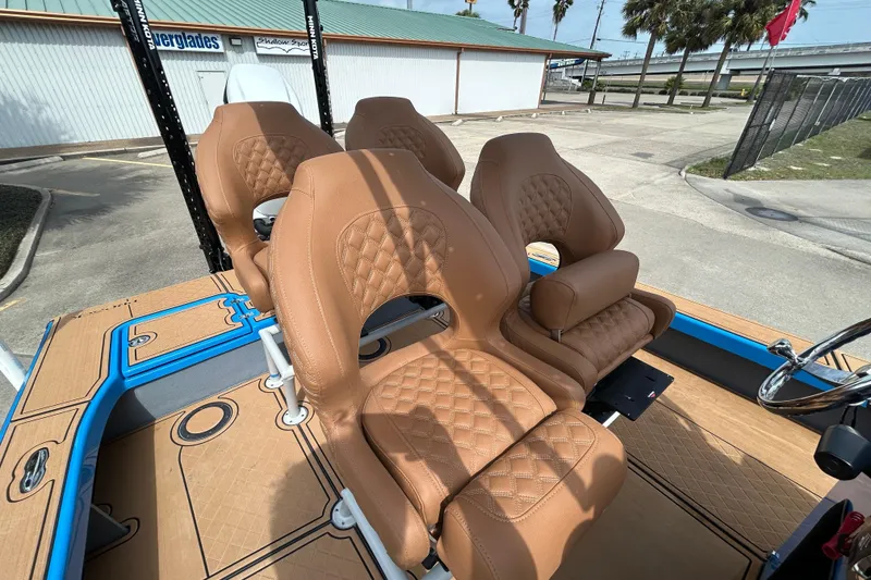 Slide: The Image of Luxurious tan seats on 2026 Skuta 24 Skuta Cat boat, featuring diamond stitching. - 13