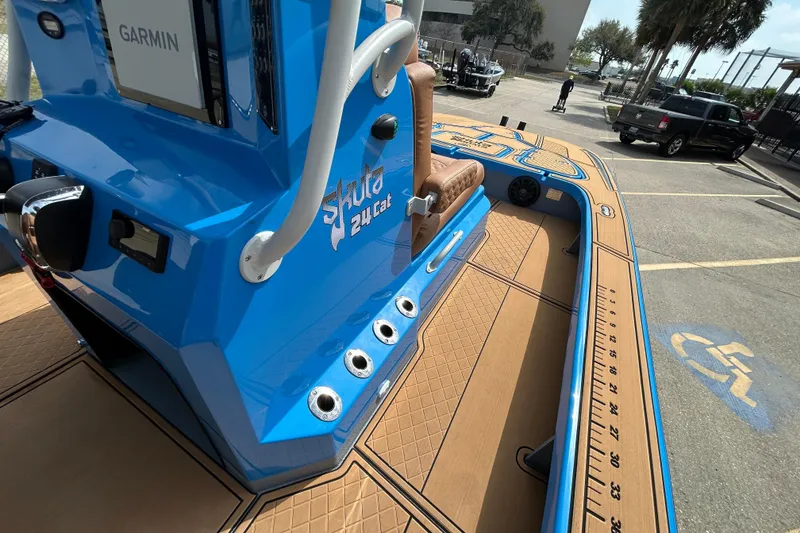 Slide: The Image of Blue 2026 Skuta 24 Cat boat with Garmin equipment, parked in a lot. - 15