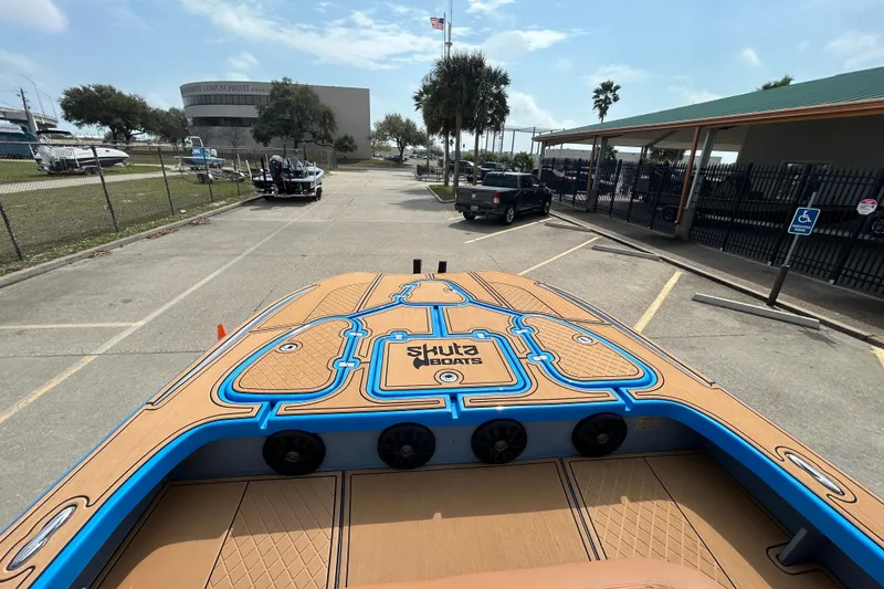 Slide: The Image of 2026 Skuta 24 Skuta Cat boat parked, showcasing deck design and branding. - 17