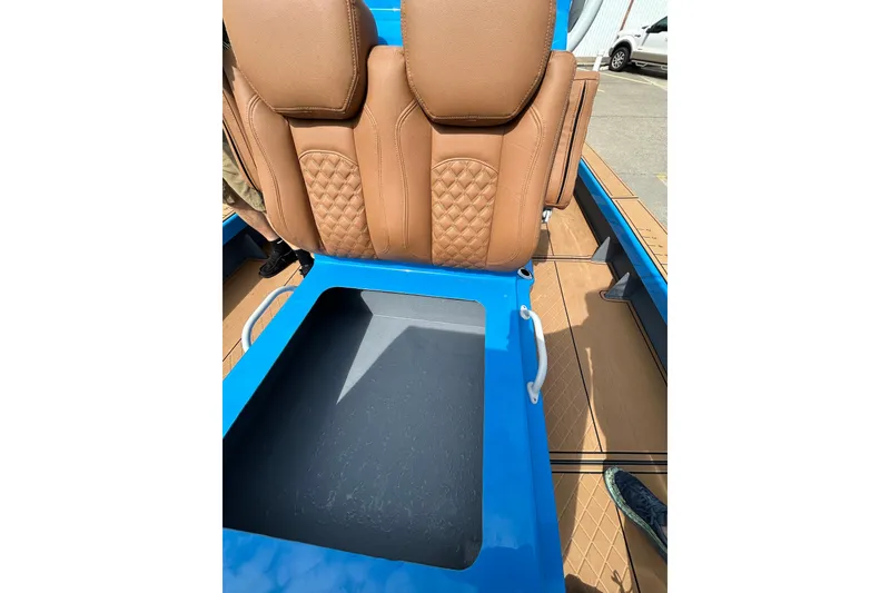 Slide: The Image of Brown leather seats and storage compartment in 2026 Skuta 24 Skuta Cat boat. - 20