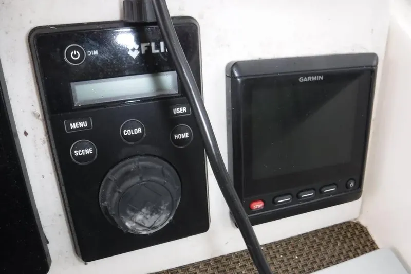 Slide: The Image of FLIR and Garmin control panels on a 2014 Grady-White Freedom 335 boat. - 11