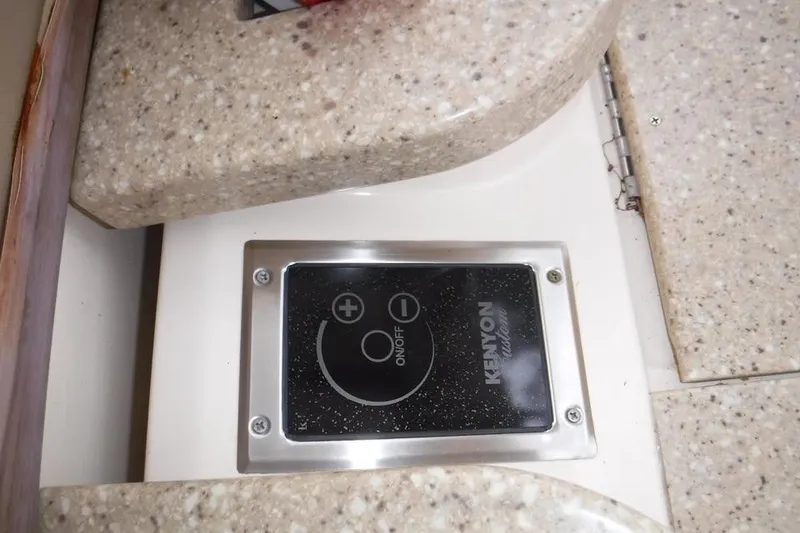 Slide: The Image of Kenyon control panel on 2014 Grady-White Freedom 335 boat interior. - 13