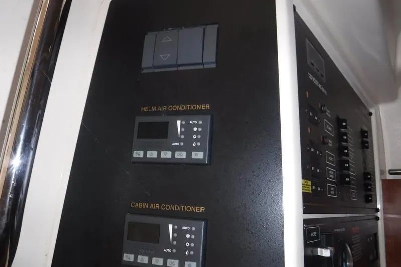 Slide: The Image of 2014 Grady-White Freedom 335 air conditioning controls for helm and cabin. - 14