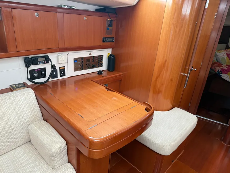Slide: The Image of Interior of 2007 Beneteau 49 yacht with wooden cabinetry and navigation station. - 12