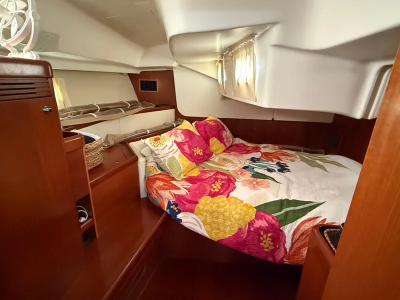 Slide: The Image of Cozy cabin interior of 2007 Beneteau 49 yacht with floral bedding and wooden accents. - 17