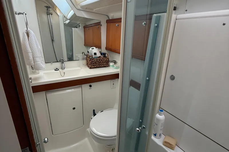 Slide: The Image of Bathroom interior of a 2007 Beneteau 49 yacht, featuring a shower, sink, and toilet. - 20