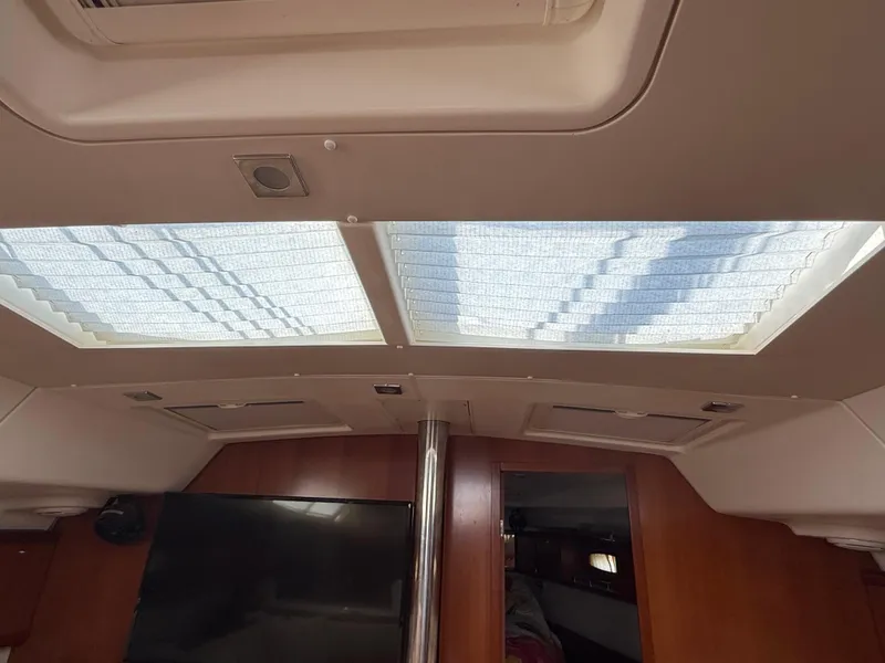 Slide: The Image of Interior view of 2007 Beneteau 49 yacht with skylights and wooden paneling. - 23