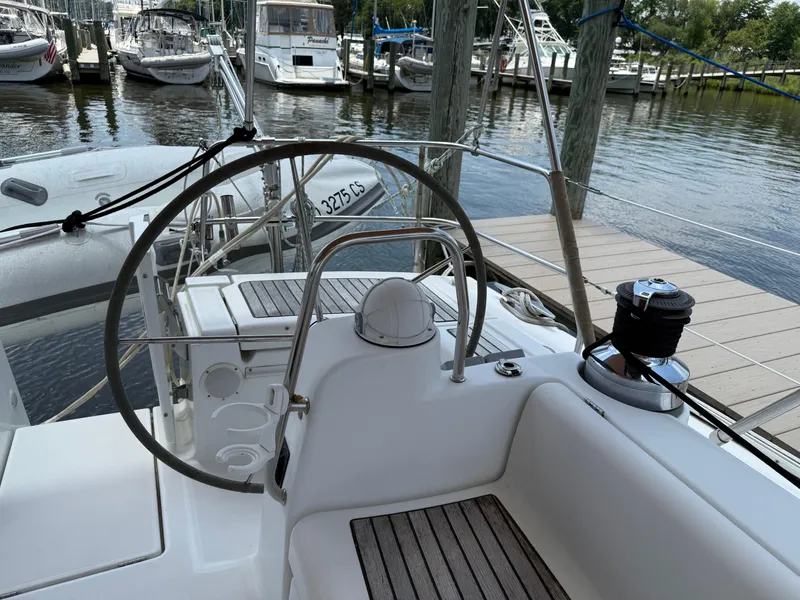 Slide: The Image of Cockpit view of a 2007 Beneteau 49 sailboat docked at a marina. - 26
