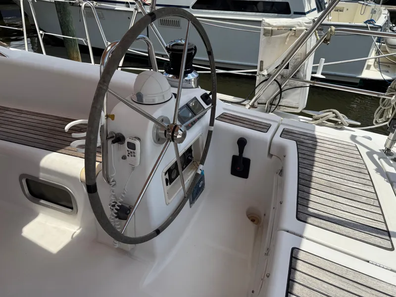 Slide: The Image of Steering wheel and controls of a 2007 Beneteau 49 sailboat cockpit. - 28