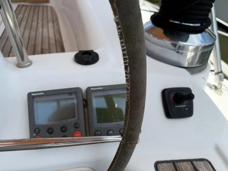 Slide: The Image of Steering wheel and navigation instruments on a 2007 Beneteau 49 sailboat. - 29