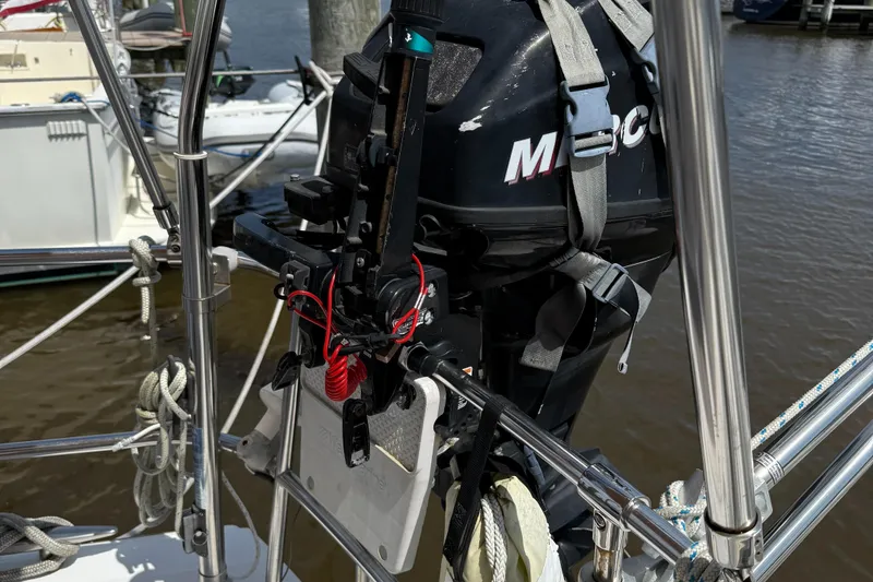 Slide: The Image of Outboard motor mounted on a 2007 Beneteau 49 sailboat at a marina. - 35
