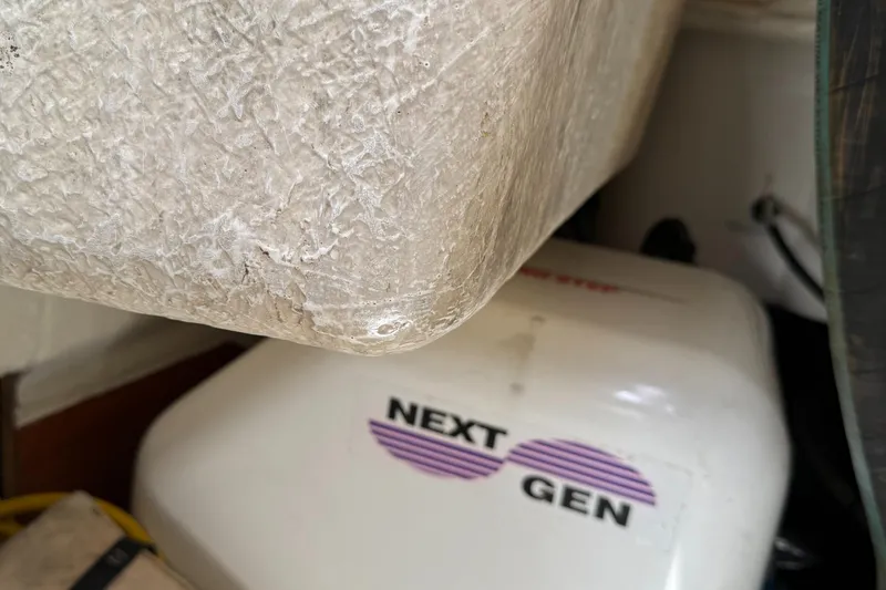 Slide: The Image of Close-up of a 2007 Beneteau 49 boat's engine compartment with "Next Gen" generator. - 36
