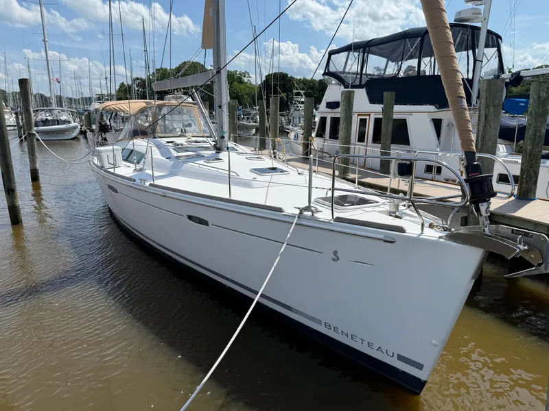 Slide: The Image of 2007 Beneteau 49 sailboat docked at marina under clear skies. - 38