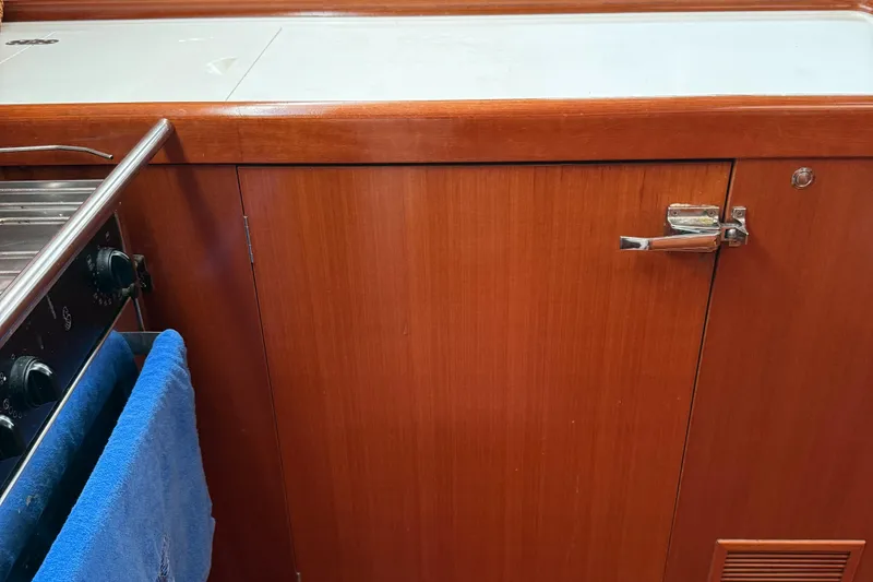 Slide: The Image of Wooden kitchen cabinet and stove in a 2007 Beneteau 49 yacht galley. - 7
