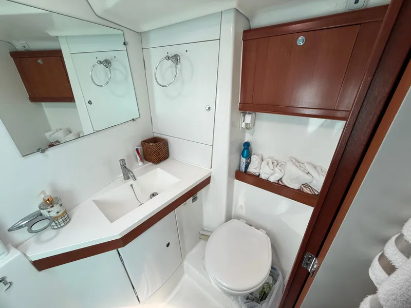 Slide: The Image of Bathroom interior of 2007 Beneteau 49 yacht, featuring sink, mirror, and storage cabinets. - 9