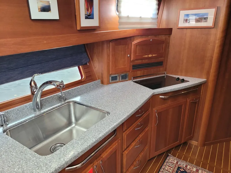 Slide: The Image of 2014 Sabre 48 Salon Express kitchen with granite countertops and stainless steel sink. - 10