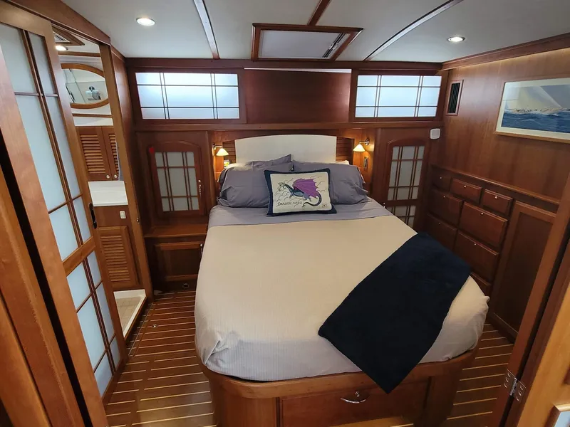 Slide: The Image of Luxurious 2014 Sabre 48 Salon Express bedroom with elegant wood finish and cozy bedding. - 11