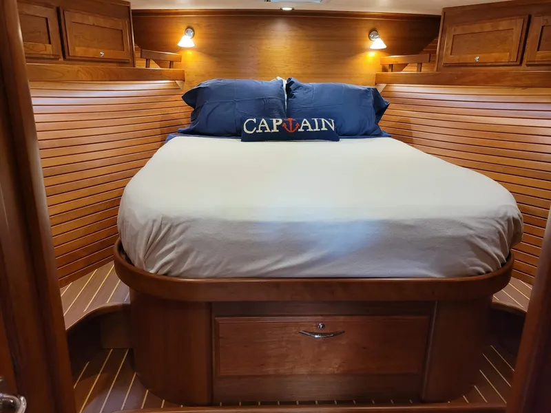 Slide: The Image of Luxurious 2014 Sabre 48 Salon Express cabin with cozy bed and wooden interior. - 13