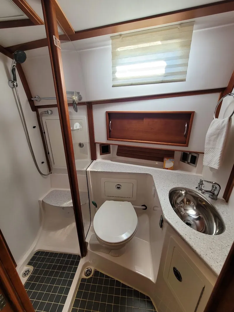 Slide: The Image of 2014 Sabre 48 Salon Express bathroom with shower, sink, and toilet. - 14