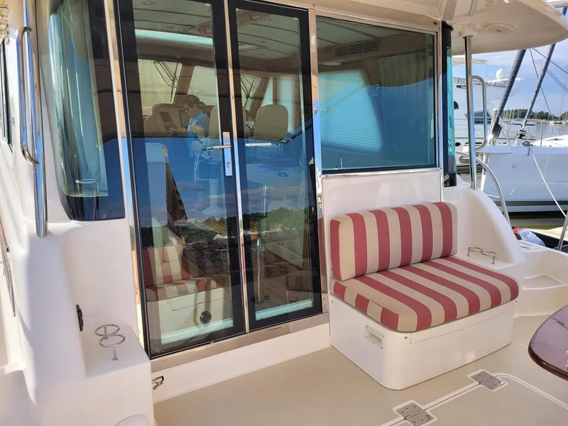 Slide: The Image of 2014 Sabre 48 Salon Express yacht with striped seating and glass doors. - 4