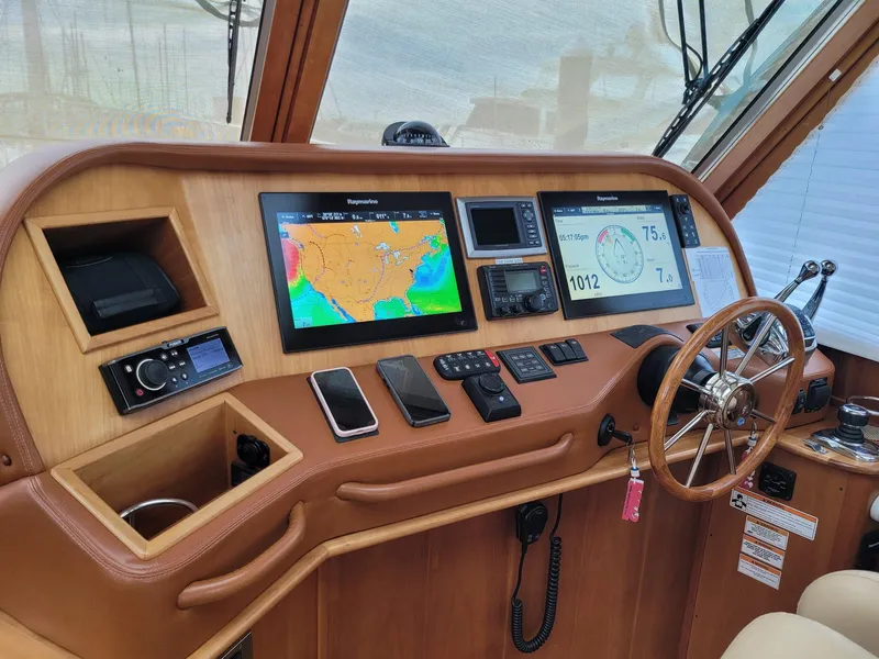 Slide: The Image of Helm of 2014 Sabre 48 Salon Express with navigation screens and controls. - 6